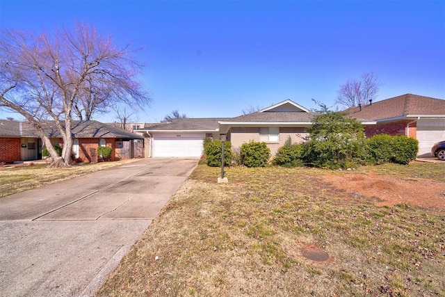 ranch-style house featuring a garage and a front lawn