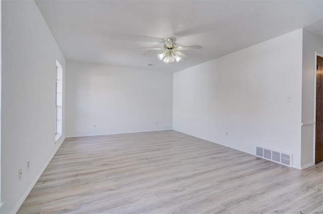 empty room with ceiling fan and light hardwood / wood-style floors