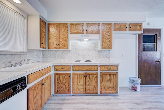 kitchen featuring sink, white appliances, backsplash, and light wood-type flooring