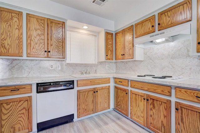 kitchen featuring tasteful backsplash, white appliances, sink, and light hardwood / wood-style flooring