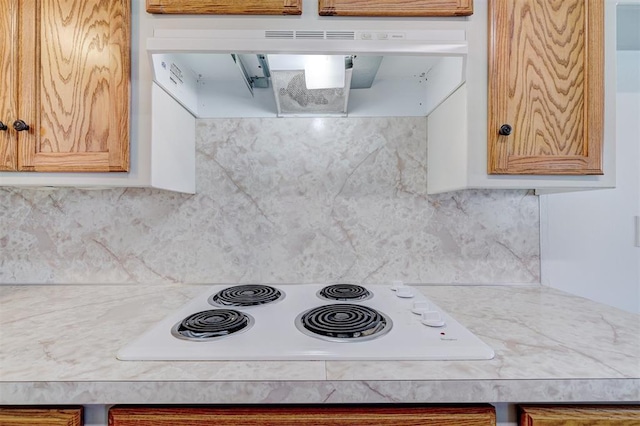 kitchen with tasteful backsplash and white electric stovetop