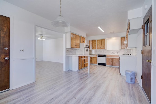 kitchen featuring pendant lighting, tasteful backsplash, ceiling fan, white appliances, and light hardwood / wood-style flooring