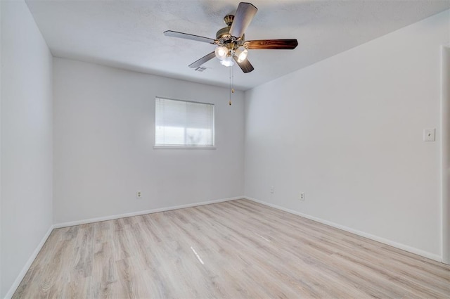 spare room featuring ceiling fan and light hardwood / wood-style flooring