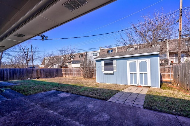 view of yard featuring a storage shed and a patio