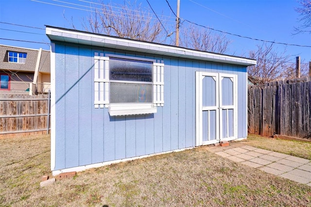 view of outbuilding featuring a yard