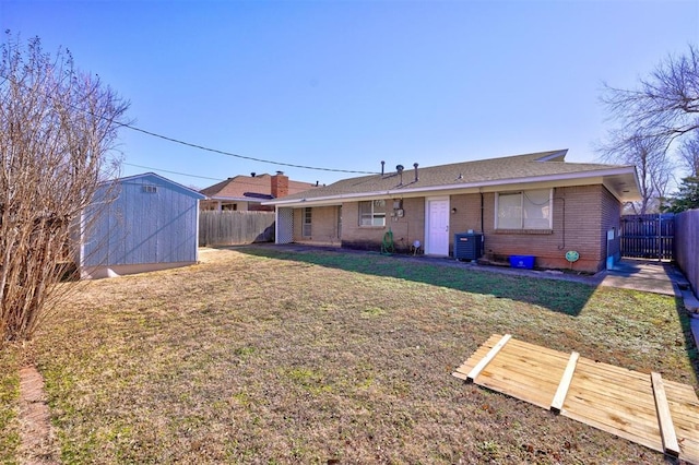 back of house with a yard, central AC, and a shed