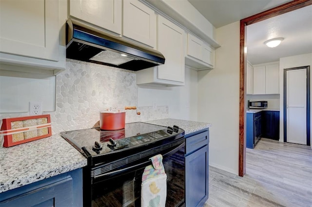 kitchen with tasteful backsplash, white cabinets, exhaust hood, light hardwood / wood-style floors, and black range with electric cooktop