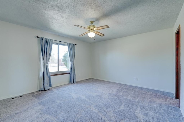 unfurnished room with light colored carpet, a textured ceiling, and ceiling fan