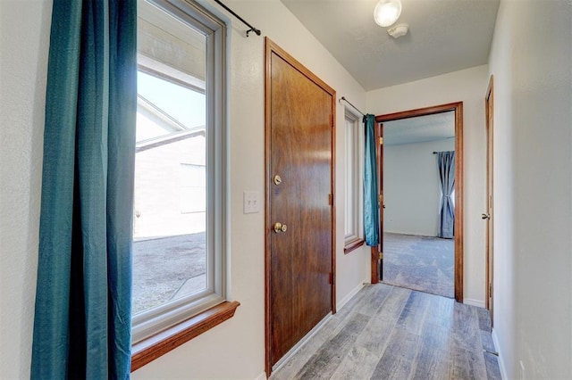 hall with light hardwood / wood-style flooring