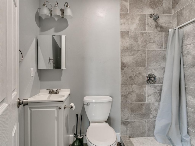 bathroom with walk in shower, vanity, and toilet