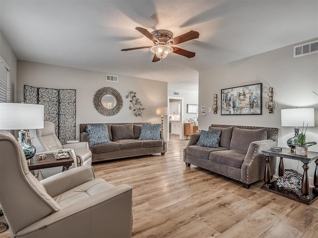 living room featuring ceiling fan and light wood-type flooring