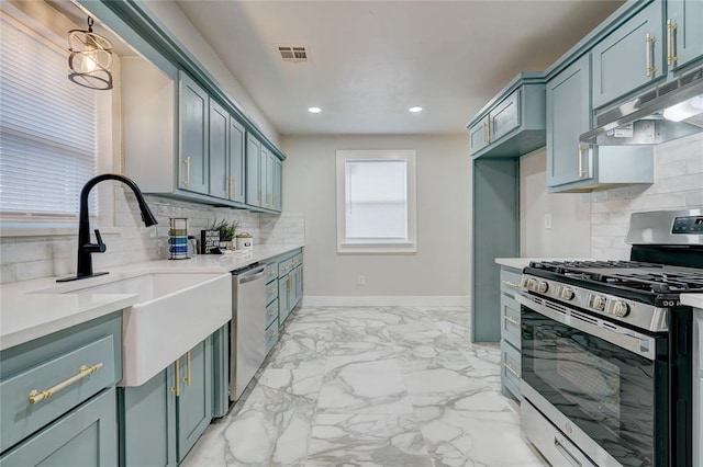 kitchen featuring tasteful backsplash, stainless steel appliances, sink, and hanging light fixtures