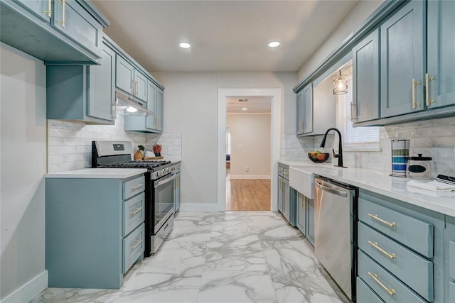 kitchen featuring stainless steel appliances, sink, and decorative backsplash