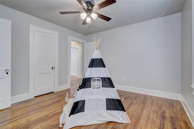 bedroom with ceiling fan and light hardwood / wood-style flooring