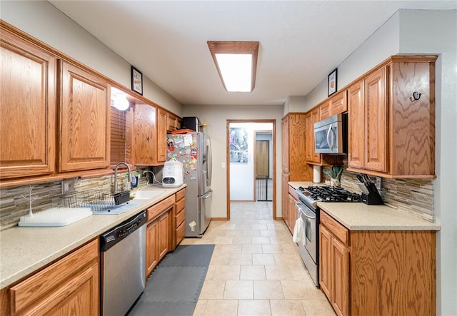 kitchen featuring backsplash, stainless steel appliances, and sink