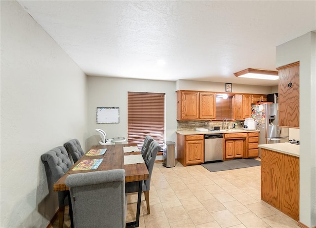 kitchen featuring tasteful backsplash, appliances with stainless steel finishes, and sink