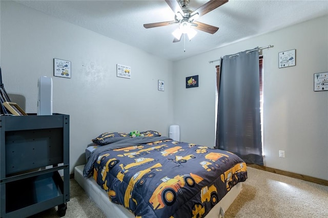 carpeted bedroom with ceiling fan and a textured ceiling