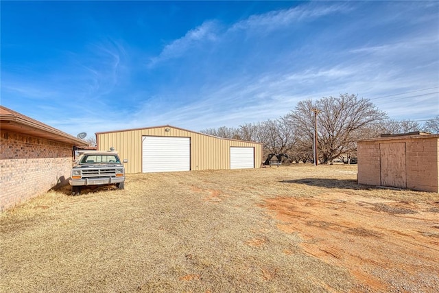 view of yard with a garage and an outdoor structure