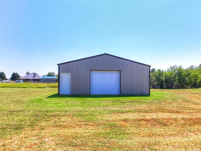 garage featuring a lawn