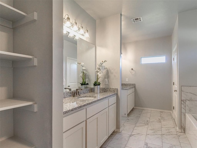 bathroom with vanity and a bath