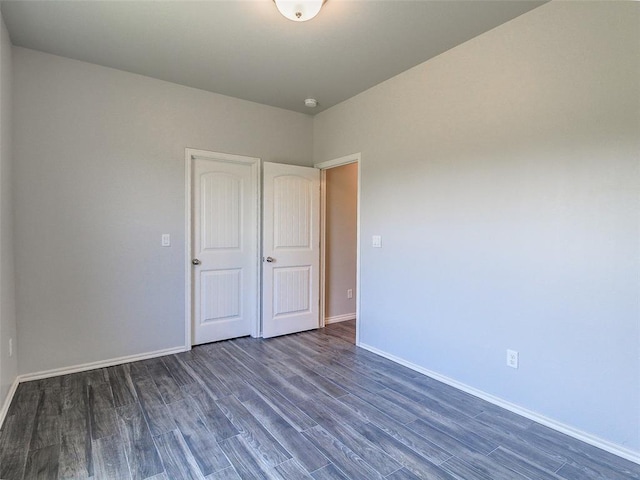 unfurnished bedroom with dark hardwood / wood-style floors