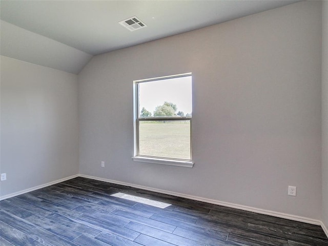 unfurnished room with dark hardwood / wood-style flooring and lofted ceiling