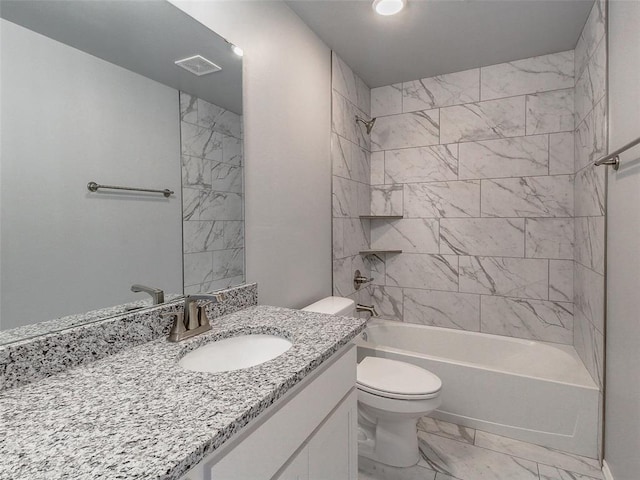 full bathroom featuring tiled shower / bath combo, vanity, and toilet