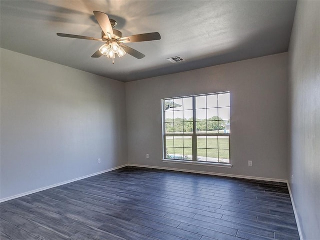 empty room with ceiling fan and dark hardwood / wood-style flooring