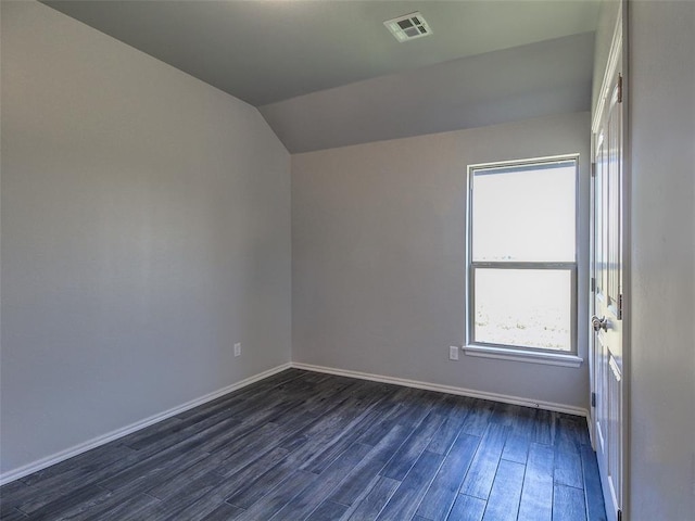 unfurnished room with dark wood-type flooring and vaulted ceiling