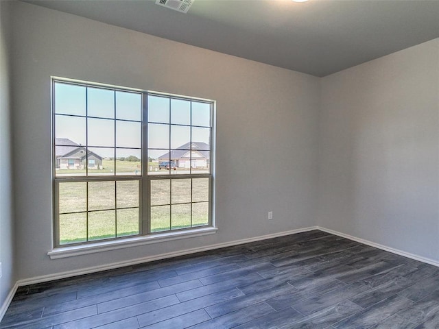 empty room featuring dark hardwood / wood-style flooring