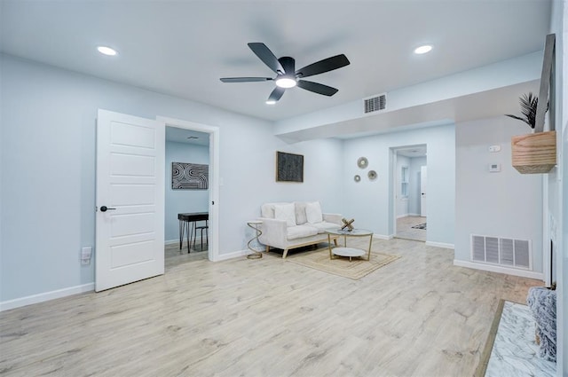 living room with ceiling fan and light wood-type flooring