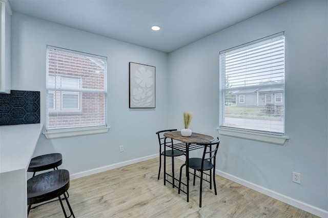 dining space with a healthy amount of sunlight and light hardwood / wood-style flooring