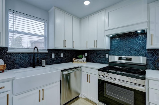 kitchen with stainless steel appliances, sink, decorative backsplash, and white cabinets