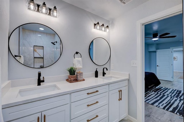 bathroom with walk in shower, ceiling fan, vanity, and hardwood / wood-style floors