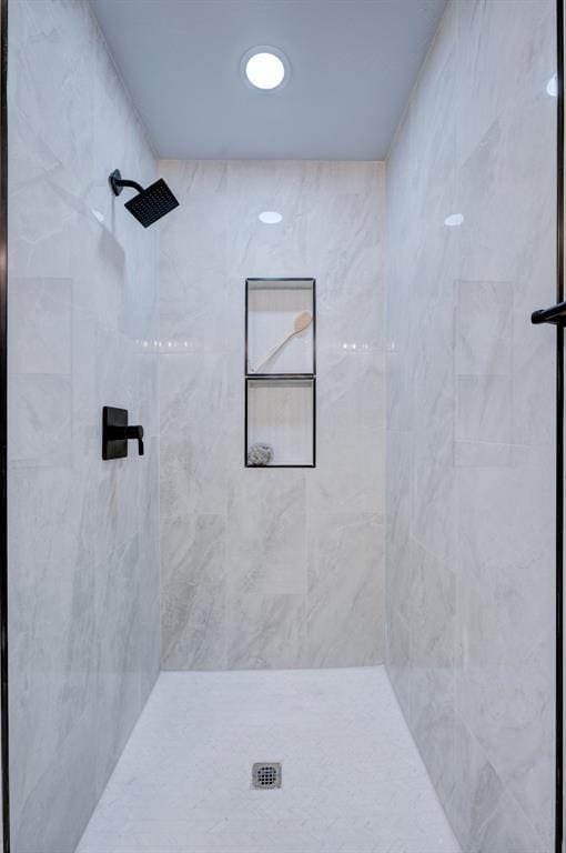 bathroom with tiled shower