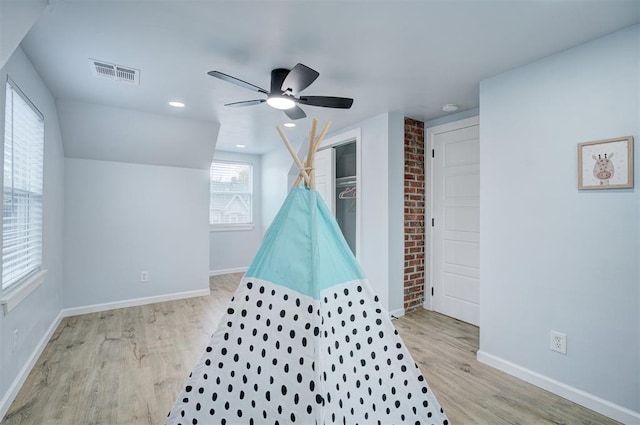 game room with light hardwood / wood-style floors and ceiling fan