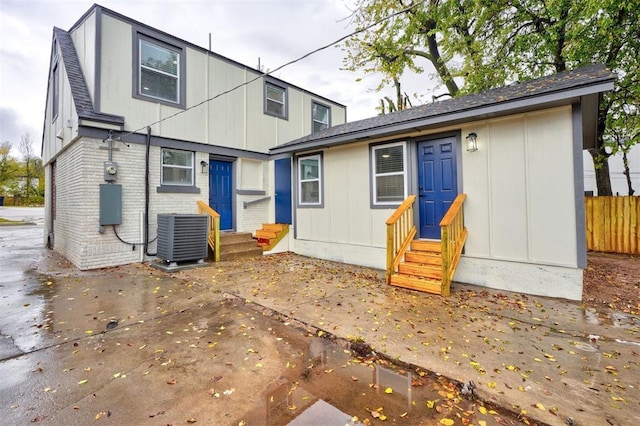 back of property with a patio area and central air condition unit