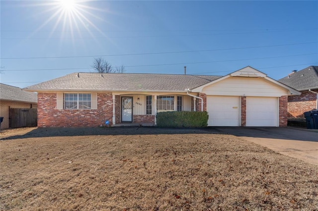 single story home with a garage and a front lawn