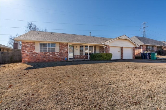 single story home with a garage and a front lawn