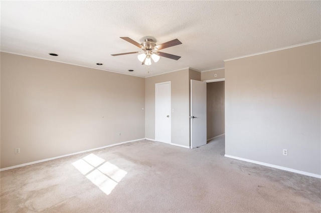 unfurnished room featuring crown molding, light colored carpet, ceiling fan, and a textured ceiling