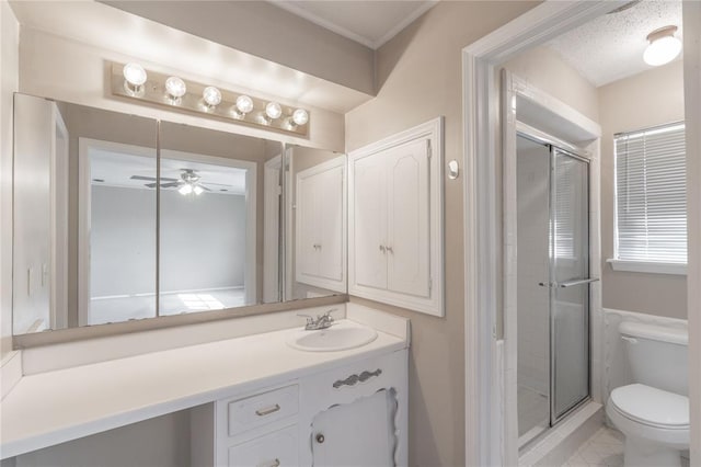 bathroom with ceiling fan, vanity, toilet, and a shower with shower door