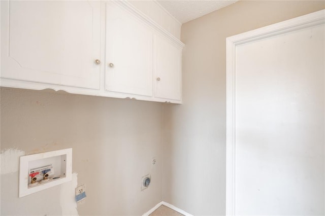 washroom with hookup for a washing machine, cabinets, a textured ceiling, and hookup for an electric dryer