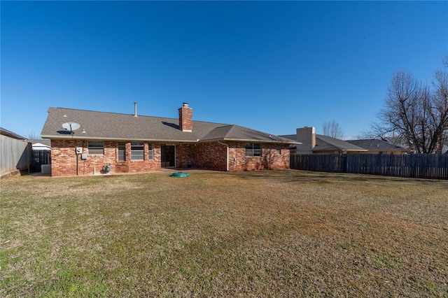 rear view of house with a yard and central air condition unit