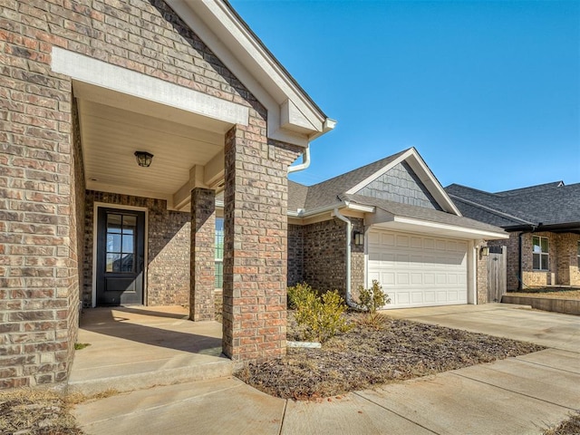 doorway to property with a garage