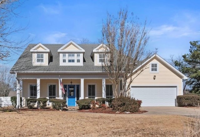 cape cod home featuring a garage, a front lawn, and a porch