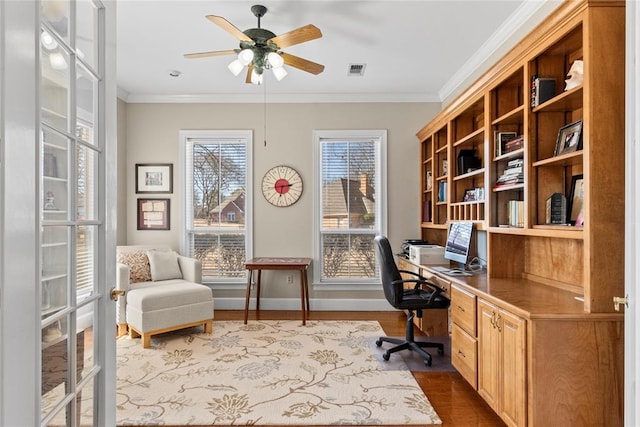 office with ceiling fan, ornamental molding, built in desk, and hardwood / wood-style floors