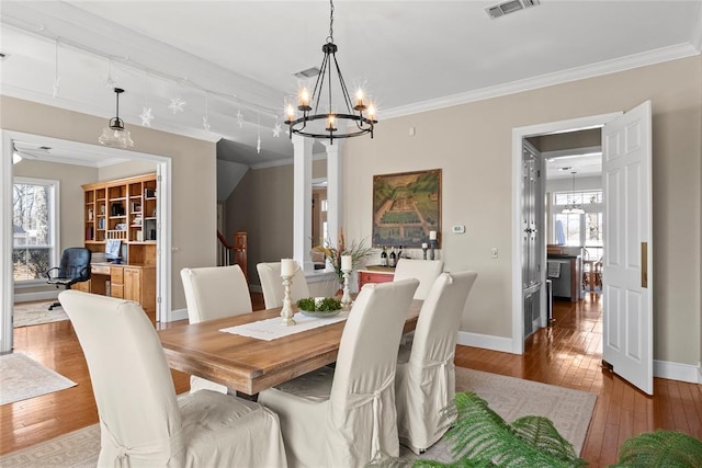 dining area featuring an inviting chandelier, hardwood / wood-style flooring, and ornamental molding