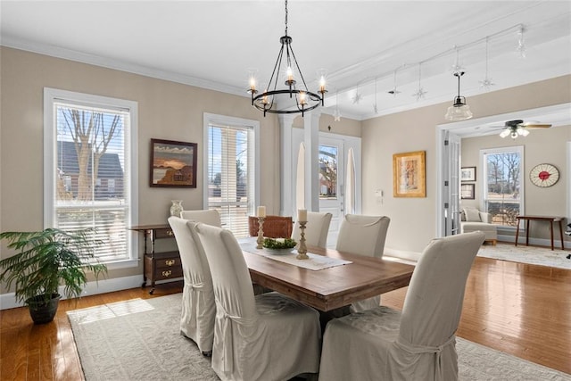 dining area featuring crown molding, ceiling fan with notable chandelier, and hardwood / wood-style floors