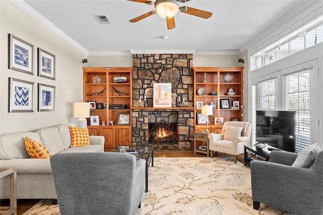 living room with crown molding, ceiling fan, a fireplace, and hardwood / wood-style flooring