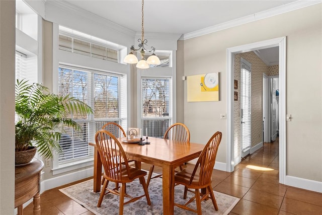 tiled dining area with a notable chandelier and ornamental molding